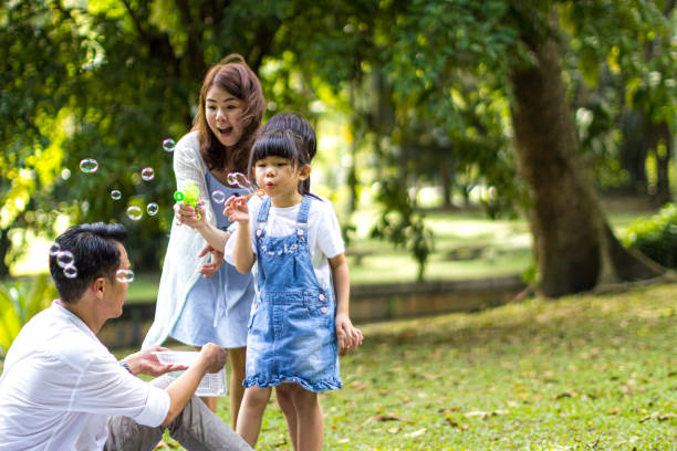istock Family blowing bubble soap 1208589681