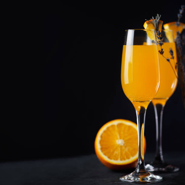 istock Mimosa cocktail with orange and champagne on a dark background copy space 1208589683