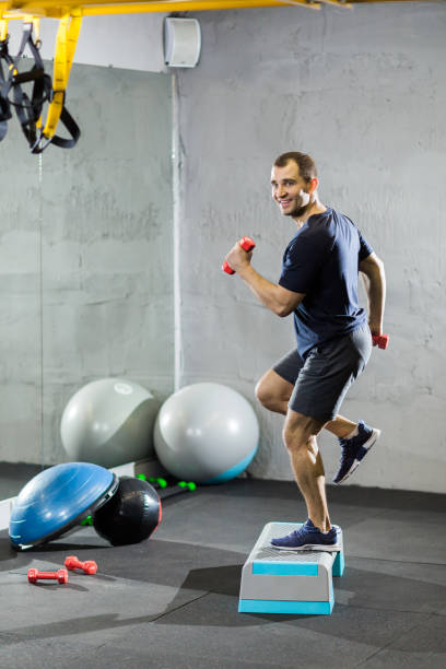 istock Fitness trainer in the gym shows exercises 1208590708