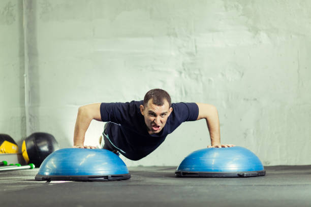 istock Fitness trainer in the gym shows exercises 1208590828