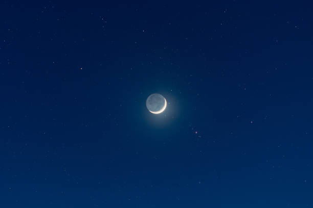istock Waxing crescent moon and starry sky 1208591031
