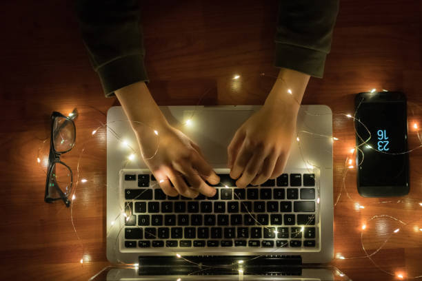 Laptop keyboard with high depth of field view reflections from glowing screen on letters.