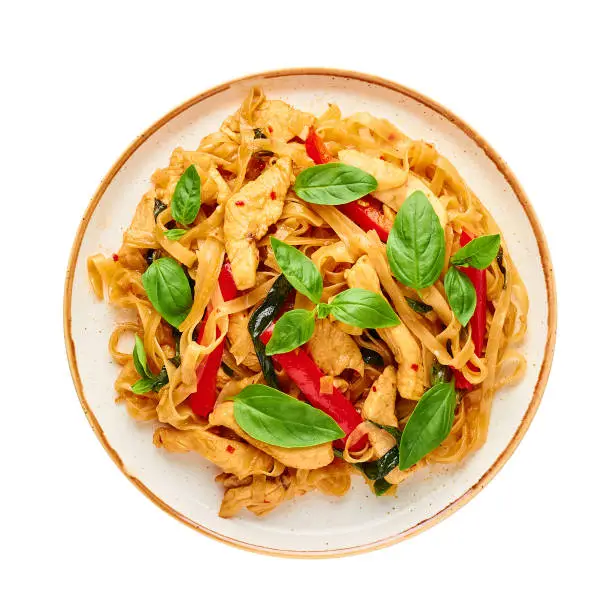 Thai Drunken Noodles or Pad Kee Mao isolated on white . Drunken Noodles is thai cuisine dish with Rice Noodles, Chicken meat, Basil, sauces and vegetables. Thai Food