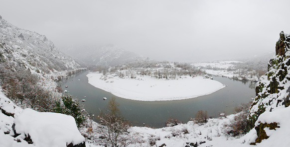 Panoramic view of Arda river in Rodopi Mountains. Kardzali province, Bulgaria, in snowy winter day