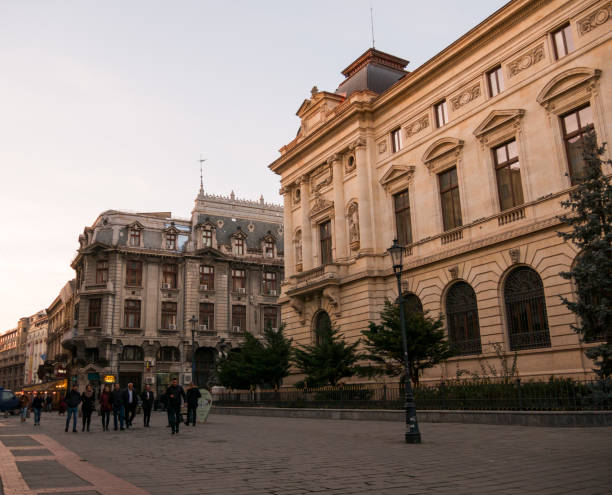 Street in the center of Bucharest, Romania. Bucharest, Romania - February 17, 2020: Group of people are walking in downtown Bucharest, walking near a bank. bucharest people stock pictures, royalty-free photos & images