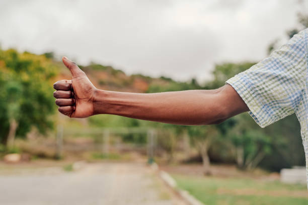 A suited man with thumbs up gesture/pose.. On yellow background. Copyspace.