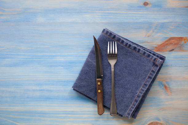 istock set of cutlery knife and fork on a blue napkin 1208595452