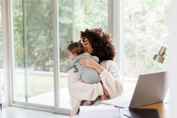 istock Mom multi-tasks while caring for newborn baby 1208596778