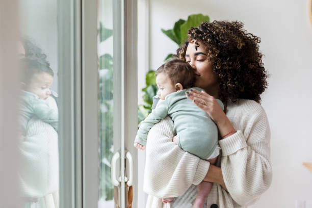istock Young mom cuddles with her baby 1208596782