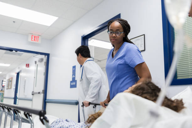 istock Caring nurse consoles patient on the way to surgery 1208596939