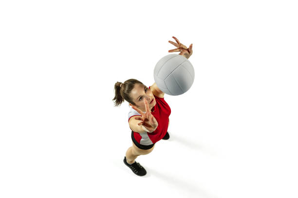 In jump and flight. Young female volleyball player isolated on white studio background. Woman in sportswear and sneakers training, playing. Concept of sport, healthy lifestyle, motion and movement.