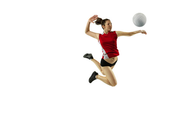 In jump and flight. Young female volleyball player isolated on white studio background. Woman in sportswear and sneakers training, playing. Concept of sport, healthy lifestyle, motion and movement.