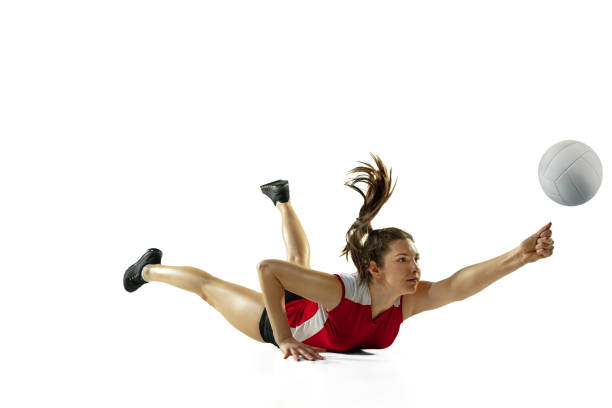 In jump and flight. Young female volleyball player isolated on white studio background. Woman in sportswear and sneakers training, playing. Concept of sport, healthy lifestyle, motion and movement.