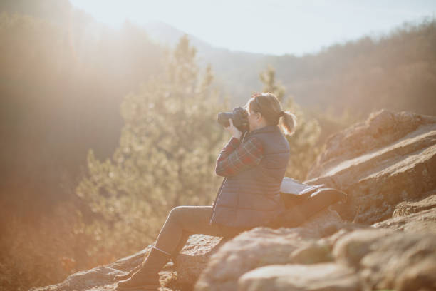 istock Senior woman using camera to capture beautiful nature around her 1208598373