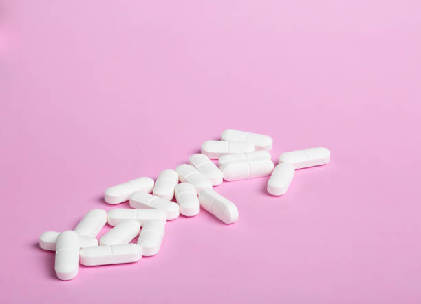 istock Heap of different white pills 1208598689