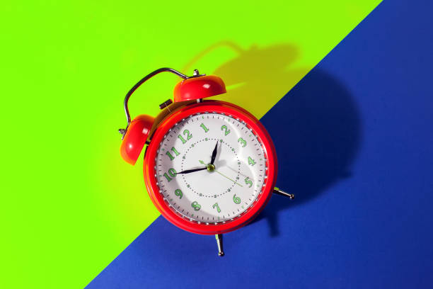istock Alarm clock is on color background. Time concept 1208599580