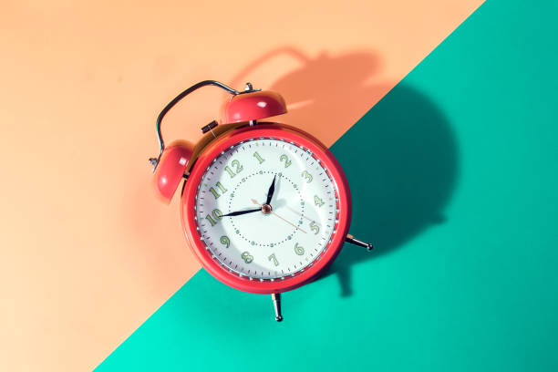 istock Alarm clock is on color background. Time concept 1208599584