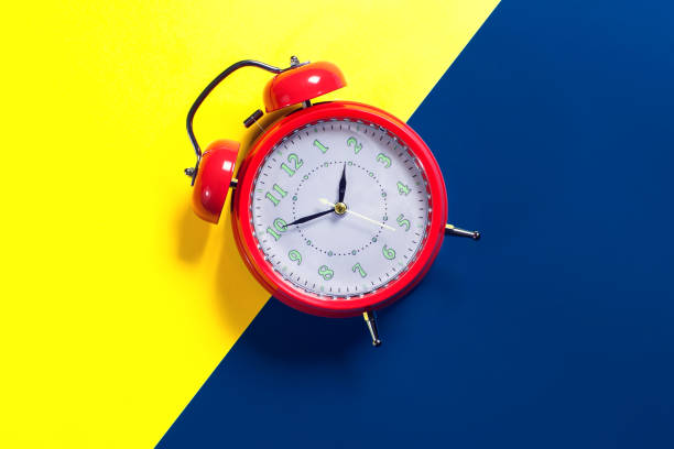 istock Alarm clock is on color background. Time concept 1208599616