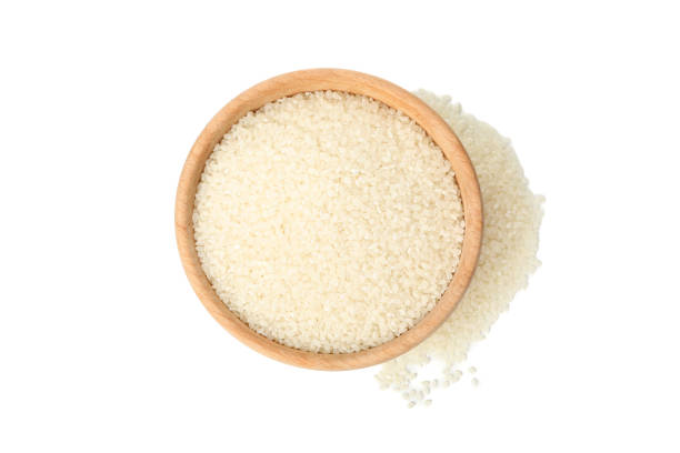 istock Wooden bowl with rice isolated on white background 1208602662