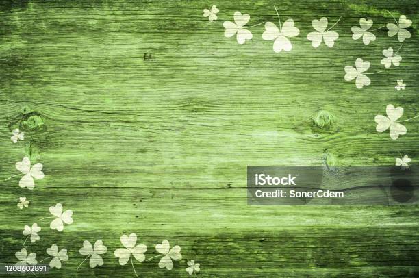 Shamrocks On Green Wooden Table A Symbol Og St Patricks Day Bbanner With Corner Border Of Shamrockstextured Pattern Stock Photo - Download Image Now