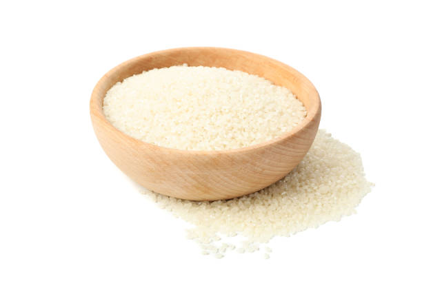 istock Wooden bowl with rice isolated on white background 1208603361