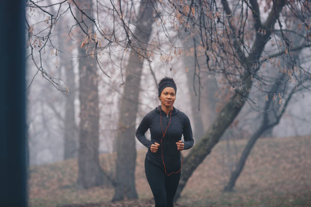 istock Happy African American athletic woman jogging 1208604146