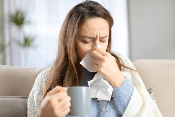 istock Young woman suffering from cold 1208604494