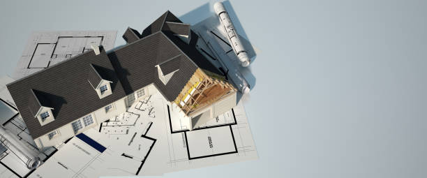 istock Unfinished house on top of blueprints 1208604841