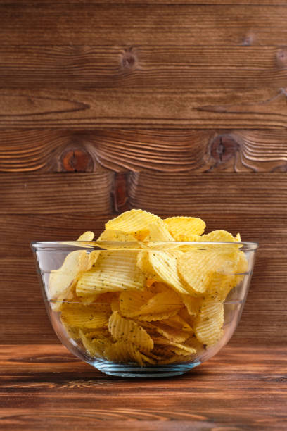 istock Glassware with chips on a background of burnt wooden background with copy space. Vertical. 1208604942
