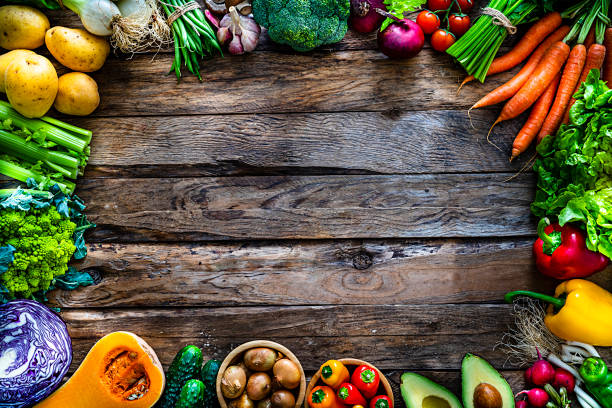 istock Healthy fresh vegetables border on wooden table. Copy space. 1208606370