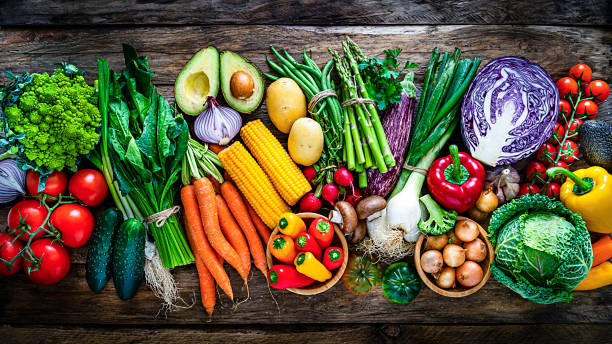 istock Healthy fresh vegetables in a row on rustic wooden table 1208606398