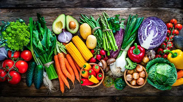 Photo of Healthy fresh vegetables in a row on rustic wooden table