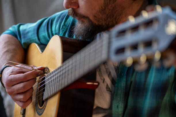 istock Guitarist Tuning Handmade Classic Guitar With Diapason 1208606568