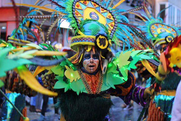 Colour Costume Mardi Gras Parade, Belgium Aalst, Belgium, 23 February 2020: Unknown carnival participant in colorful costume dances in the annual Mardi Gras parade. The street parade attracts thousands of spectators each year. mardi gras body painting stock pictures, royalty-free photos & images
