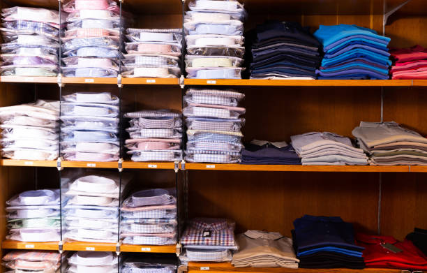 istock Clothing store. Shelves with shirts of different sizes 1208607049