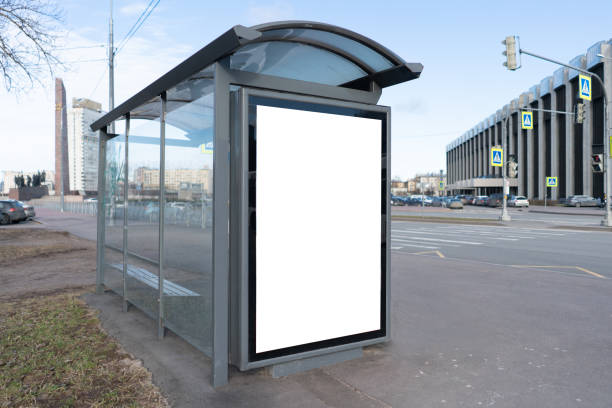 istock Vertical billboard in the stop pavilion, urban format advertising field in a small bus stop. Near the road. With white space for mock-up posters 1208610020