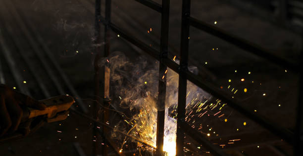 istock A welder at work in a workshop produces metal structures. Sparks from welding fly around. 1208610178