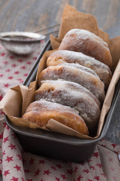 istock Sweet homemade dessert doughnuts in rustic setting on  wood boards. Selective focus on front doughnut. 1208612303