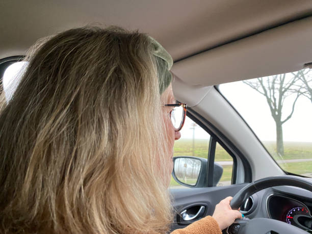 istock Car driving woman 1208614335