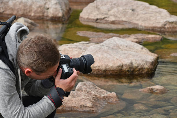 fotógrafo hombre tomando fotos del lago de montaña - travel destinations mountain hiking profile fotografías e imágenes de stock