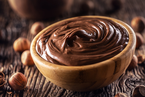 Chocolate hazelnut spread in wooden bowl - Close up.