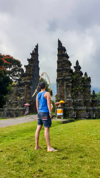 istock Buleleng - A man standing in front of Bali Handara Gate 1208617734