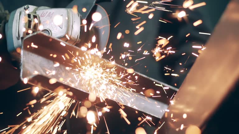 Slow motion video of rotary saw is cutting iron and causing sparks