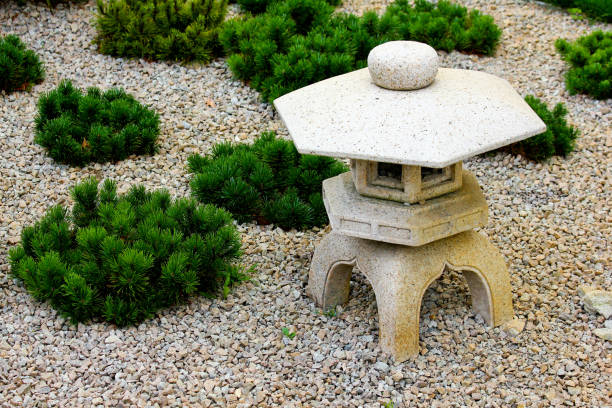 A japanese garden decoration with a stone lantern. A japanese garden decoration with a stone lantern. japanese rock garden stock pictures, royalty-free photos & images