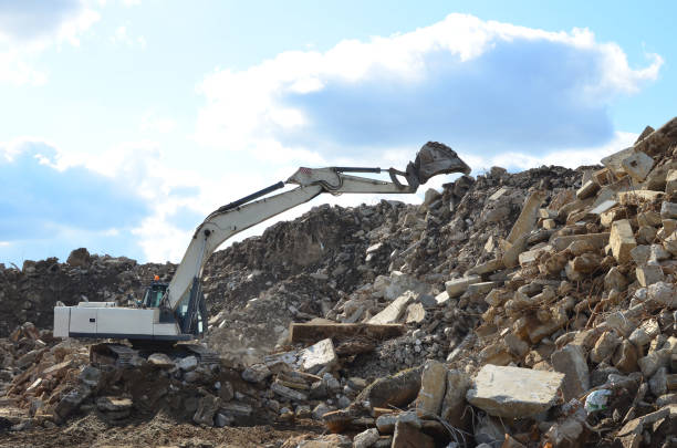 istock Excavator work at landfill with concrete demolition waste 1208618921