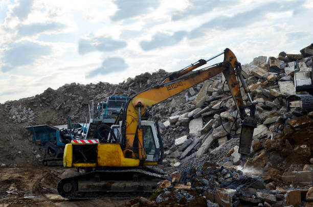 istock Excavator work at landfill with concrete demolition waste 1208618924