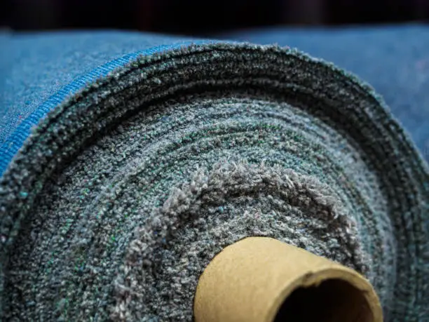Photo of A roll of denim fabric. Woven factory or warehouse