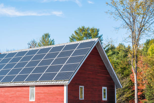 Solar panels on the roof of a farm building on a clear autumn day stock photo