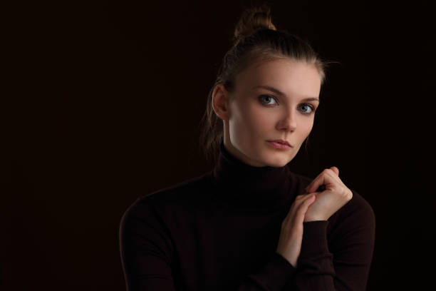 istock Beautiful girl in a maroon turtleneck on a brown background 1208623204