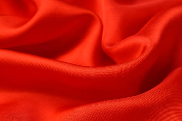 istock fabric texture. abstract background with soft waves. Smooth elegant red silk or satin luxury cloth 1208623677